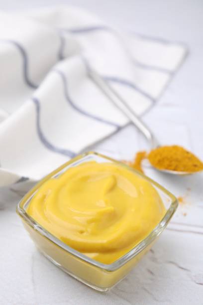 istock Tasty curry sauce and powder on white table 1683065206
