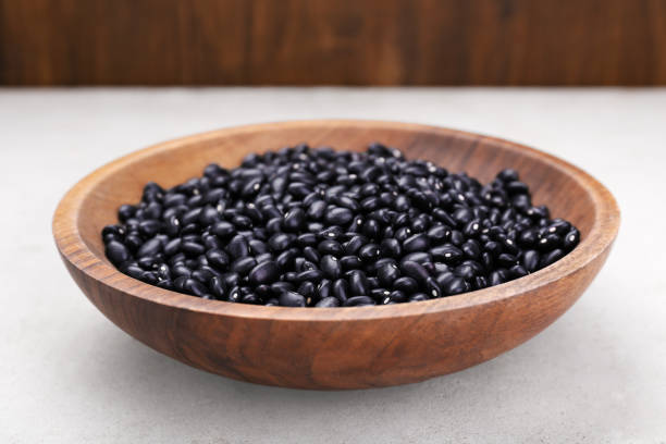 istock Bowl of raw black beans on light grey table, closeup 1683067416