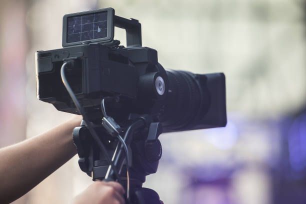 istock Operator with a video camera records a reporting event at an open public event, close-up 1683076902