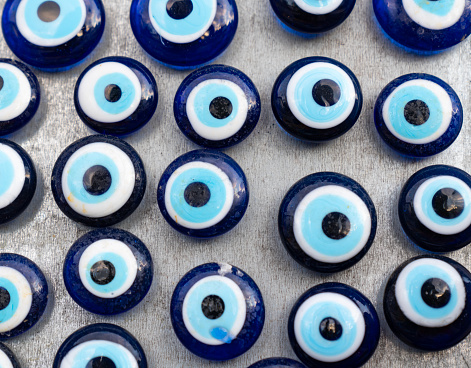 Charm from the evil eye on a blue background pattern