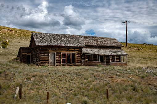 Rocky Mountain log cabin with picture window and 2 doors in Terryall in Colorado in western USA of North America. Nearest cities/towns are Colorado Springs, Denver, Fairplay, and Lake George, Colorado.