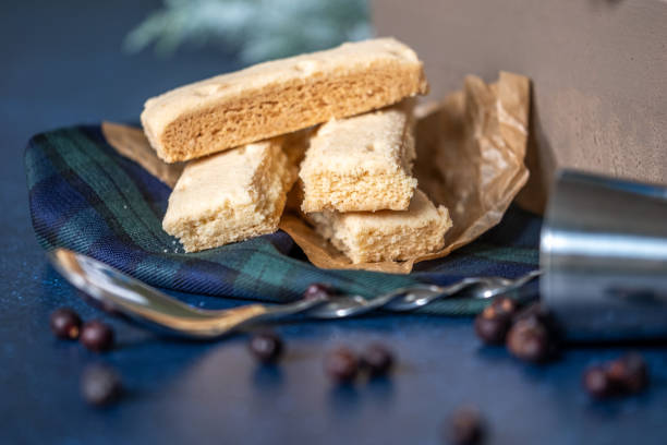 istock pile of cookies on checkered napkin, spoon, juniper seeds on table. Copy space 1683136968