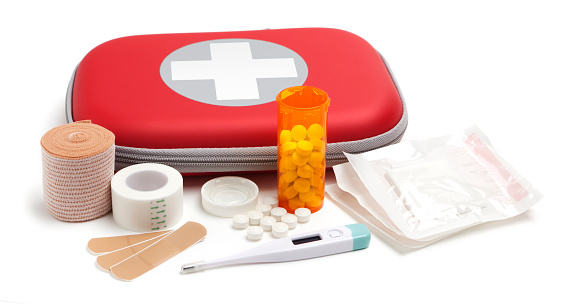 Generic first aid kit emergency supplies on white background.