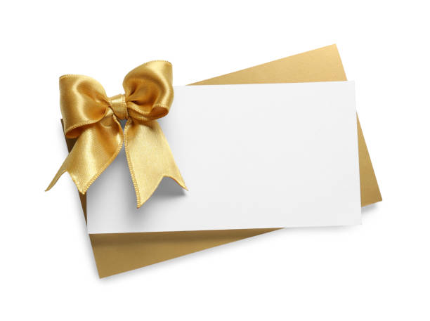 istock Blank gift card with golden bow isolated on white, top view 1683140548