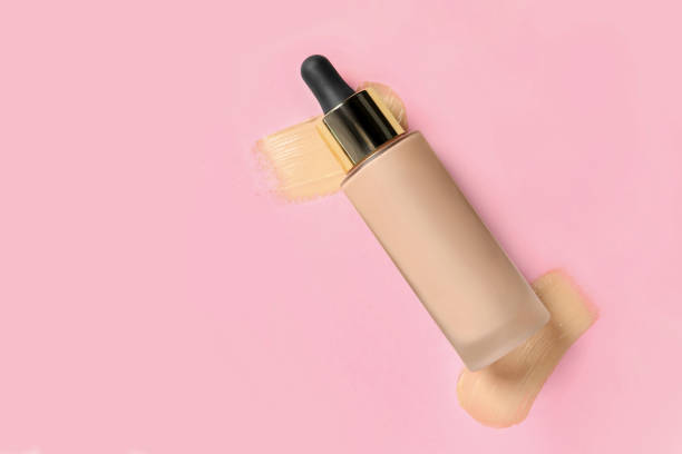 istock Liquid foundation and swatches on pink background, top view. Space for text 1683141715