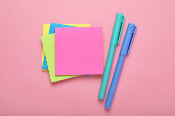 istock Paper notes and colorful markers on pink background, flat lay 1683153825