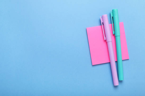 istock Paper notes and colorful markers on light blue background, top view. Space for text 1683154205