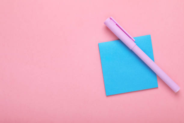 istock Paper note and purple marker on pink background, top view. Space for text 1683158142