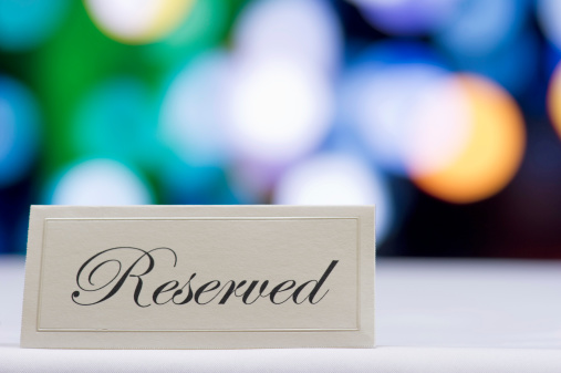 Reserved sign  with defocused lights in the background