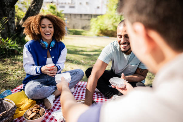 istock Friends having fun during a picnic on the public park 1683167891