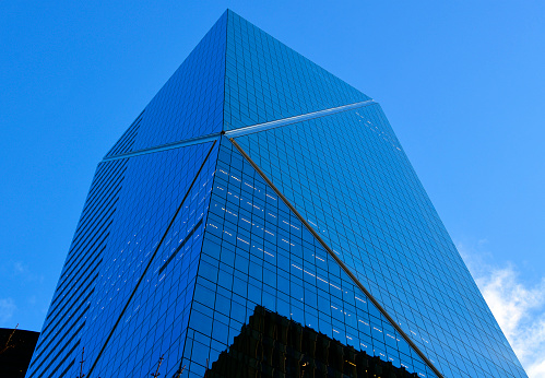 Clouds reflected in windows of modern office building