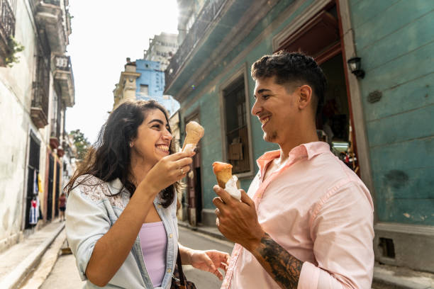 istock Young couple talking while eating ice cream cone outdoors 1683190852