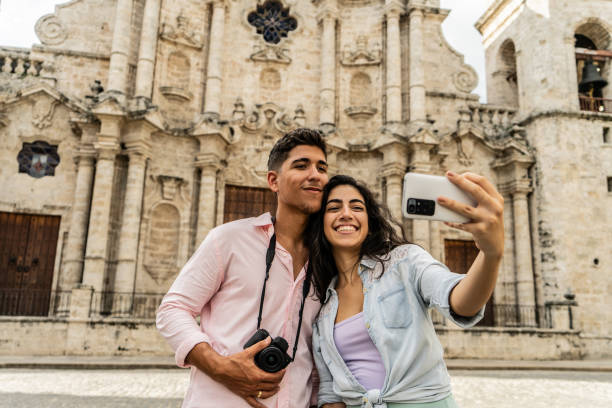 istock Young couple taking a selfie using a mobile phone  outdoors 1683191719