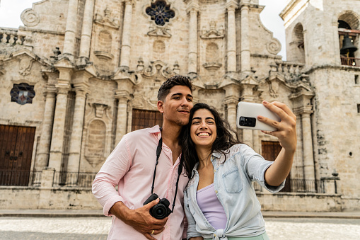 Young couple taking a selfie using a mobile phone  outdoors