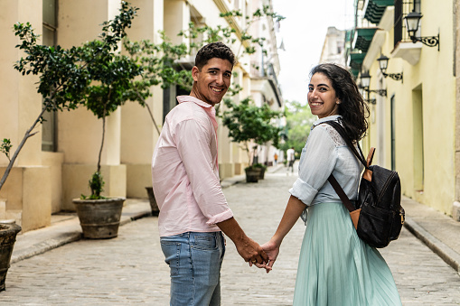 Portrait of a young couple holding hands outdoors