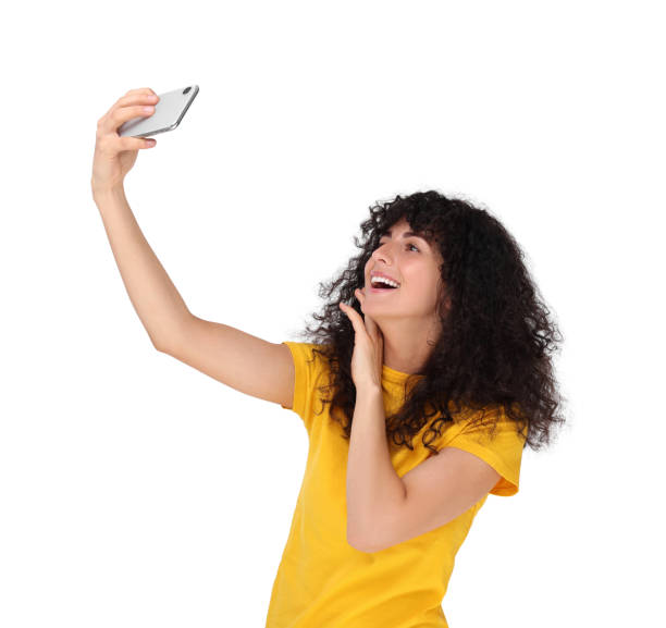 istock Beautiful young woman taking selfie on white background 1683217585