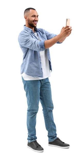 istock Smiling young man taking selfie with smartphone on white background 1683236751