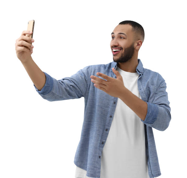 istock Smiling young man taking selfie with smartphone on white background 1683236753