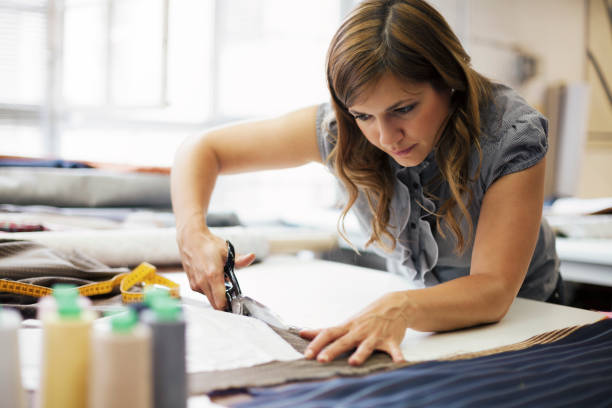 young woman working in clothes manufacture stock photo