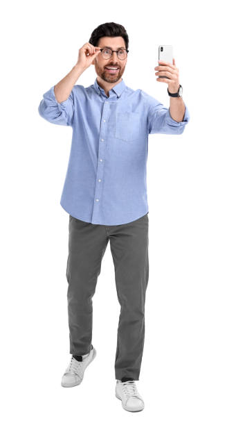 istock Smiling man taking selfie with smartphone on white background 1683245985