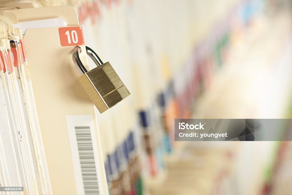 Secure Medical Records Secure and protected medical records. Bar code added to folder, not actual patient information. Concept image. Narrow depth of field. Privacy Stock Photo