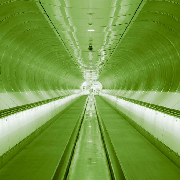 long escalator, black and white, tunnel