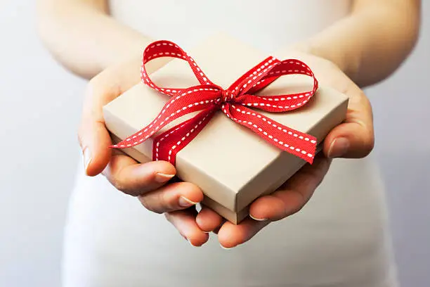 A person holding a gift box.