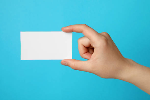 istock Woman holding blank gift card on light blue background, closeup 1683265344