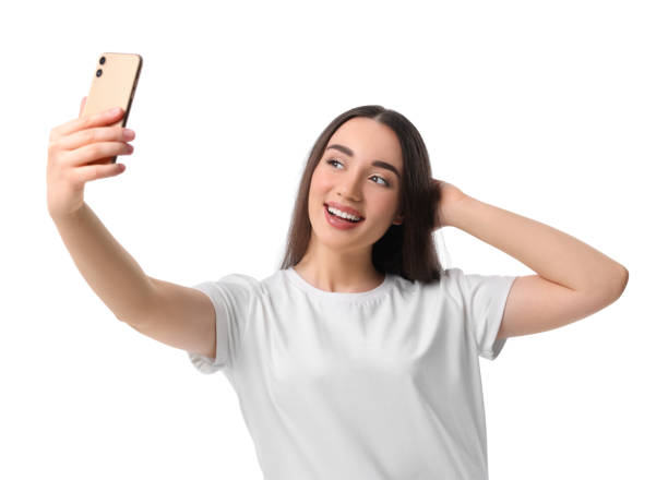 istock Smiling young woman taking selfie with smartphone on white background 1683265905
