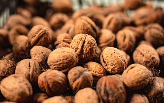 Greek Raw walnut kernels whole . Group. Brown nutshell pattern. Vegan organic snacks.
