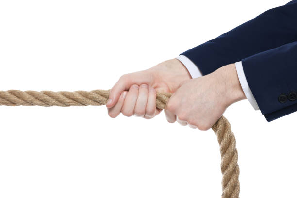 istock Dispute concept. Man pulling rope on white background, closeup 1683284769