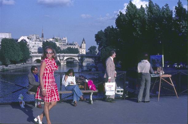 Paris, Il de France, France, 1976. Street scene with Parisians and tourists along the Seine.