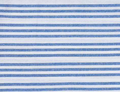 Texture of linen white towel with blue stripes, close up