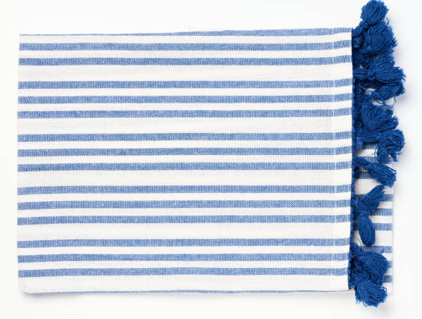 istock Folded white blue linen napkin with pom pom on a white isolated background, top view 1683308147
