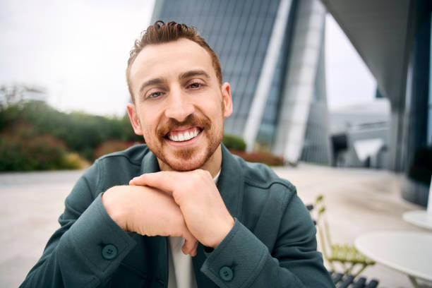 istock Man having video conference sitting outdoors. Happy student studying, online lesson 1683309449