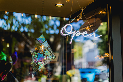 Close-up on a open sign hanging on the door of a local small business in Downtown Camas Washington - small business concepts local to the greater Portland Oregon Area