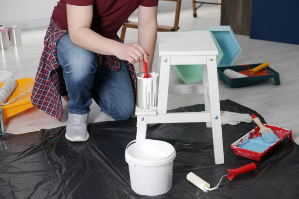 istock Man using brush to paint bekvam with white dye indoors, closeup 1683314484