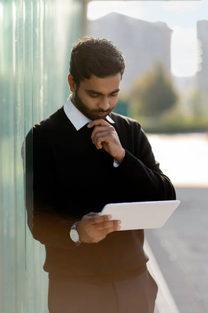 istock Indian man using digital tablet on the street 1683330765