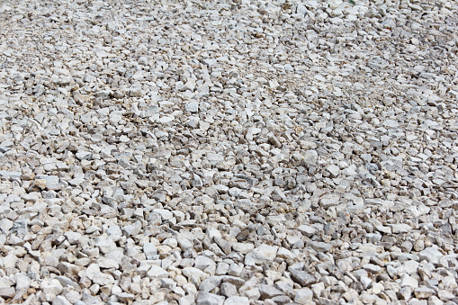 Gravel of large fractions Crushed stone building aggregate stone structure. Crushed Stone close-up Lies on ground. Breakstone. Granite gravel construction materials. Focus on center photo