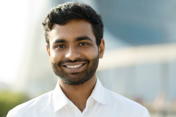 istock Smiling Indian student looking at camera standing in university campus. Education concept 1683332924