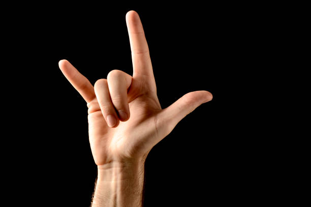 istock Rock and roll hand sign isolated on black background 168334742