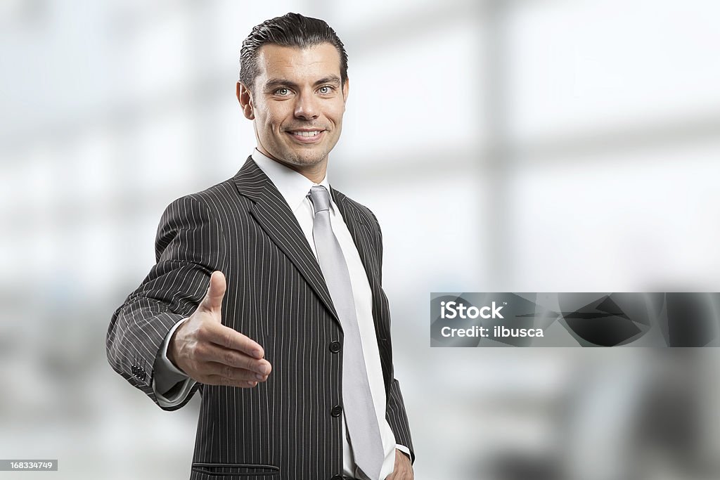 Young businessman giving handshake Elegance Stock Photo