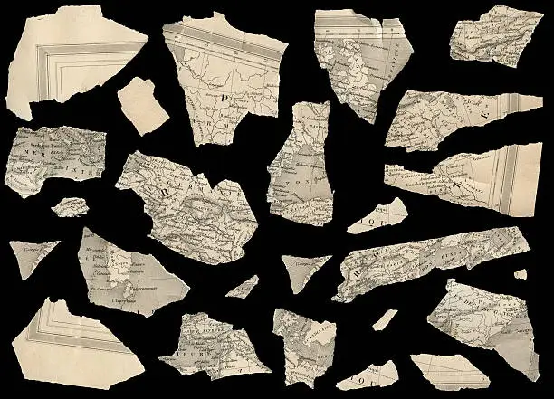 pieces of an antique fragmented french map against black