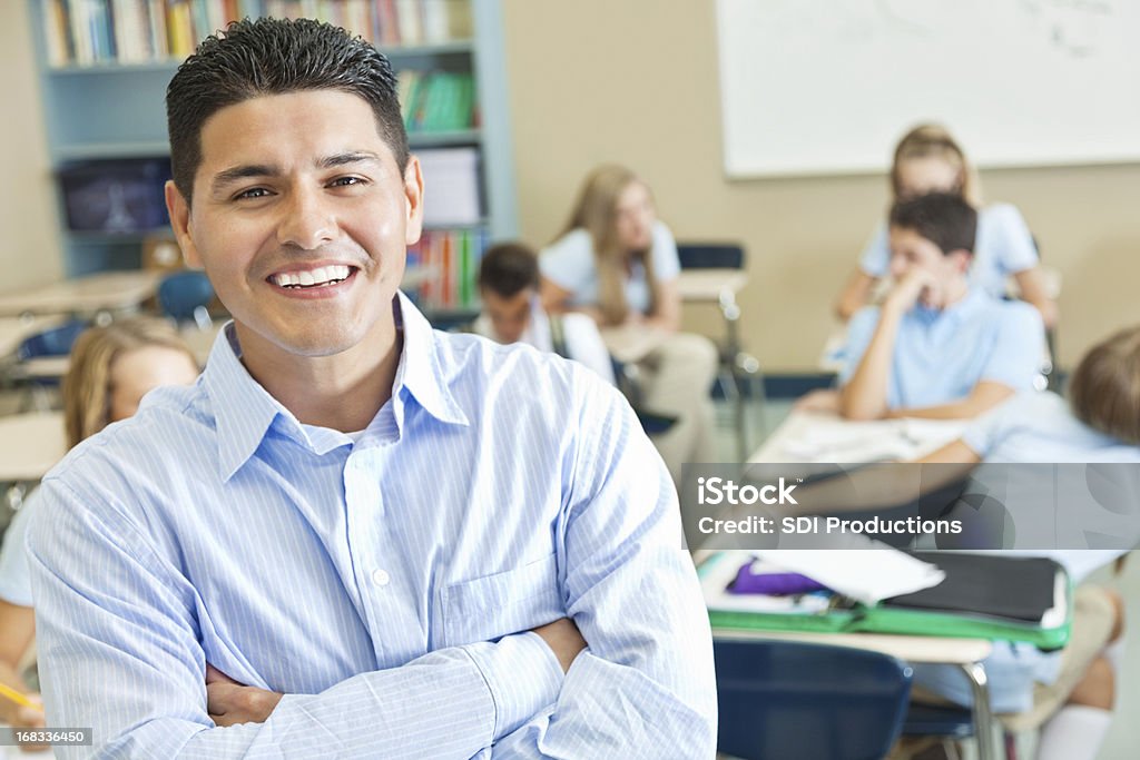 Улыбающаяся учитель в своем классе полный студентов - Стоковые фото Учитель роялти-фри