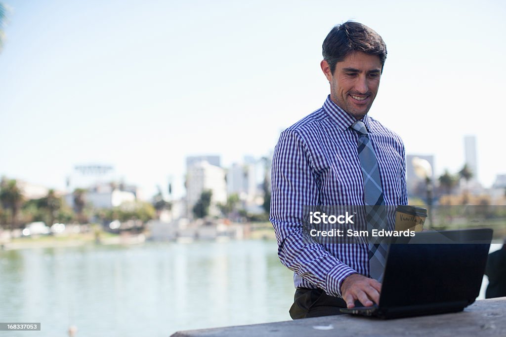 Бизнесмен работает на ноутбуке в парке - Стоковые фото 30-34 года роялти-фри