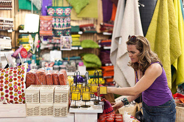 Woman buying a gift Caucasian woman buying a souvenir in a gift shop discount store stock pictures, royalty-free photos & images