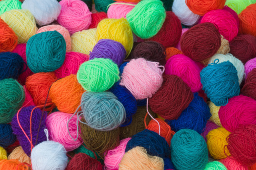 Brightly coloured collection of wool on sale in a market in Peru