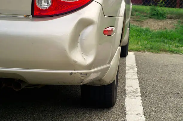 Car with dented bumper.