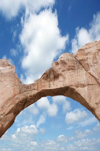 natural arch bridge in close-up with bright sky, vertical frame (XXXL)