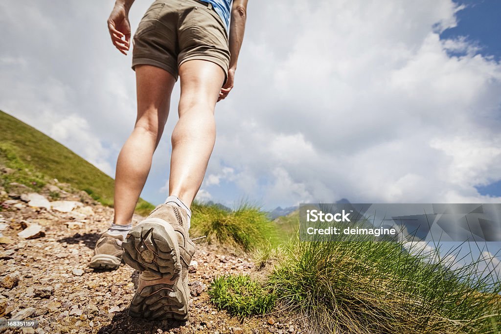 Hiker walks on Mountain Trail Women hikers on the path.  Close-up Stock Photo